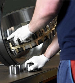 man working on a giant ball bearing