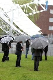 people standing with umbrellas