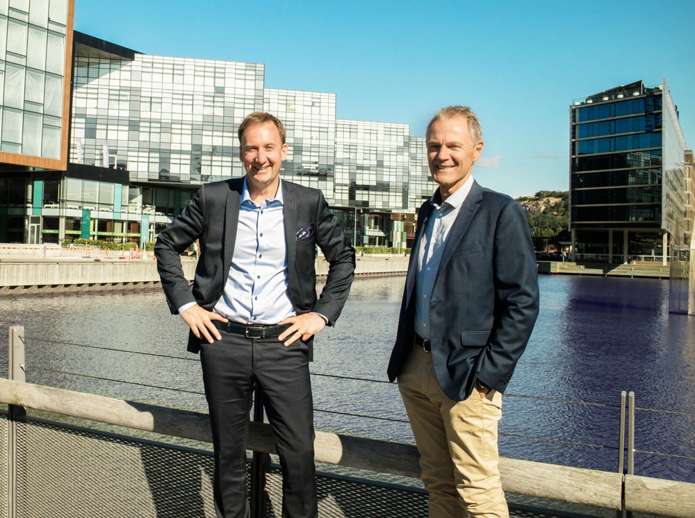 two men standing on a bridge