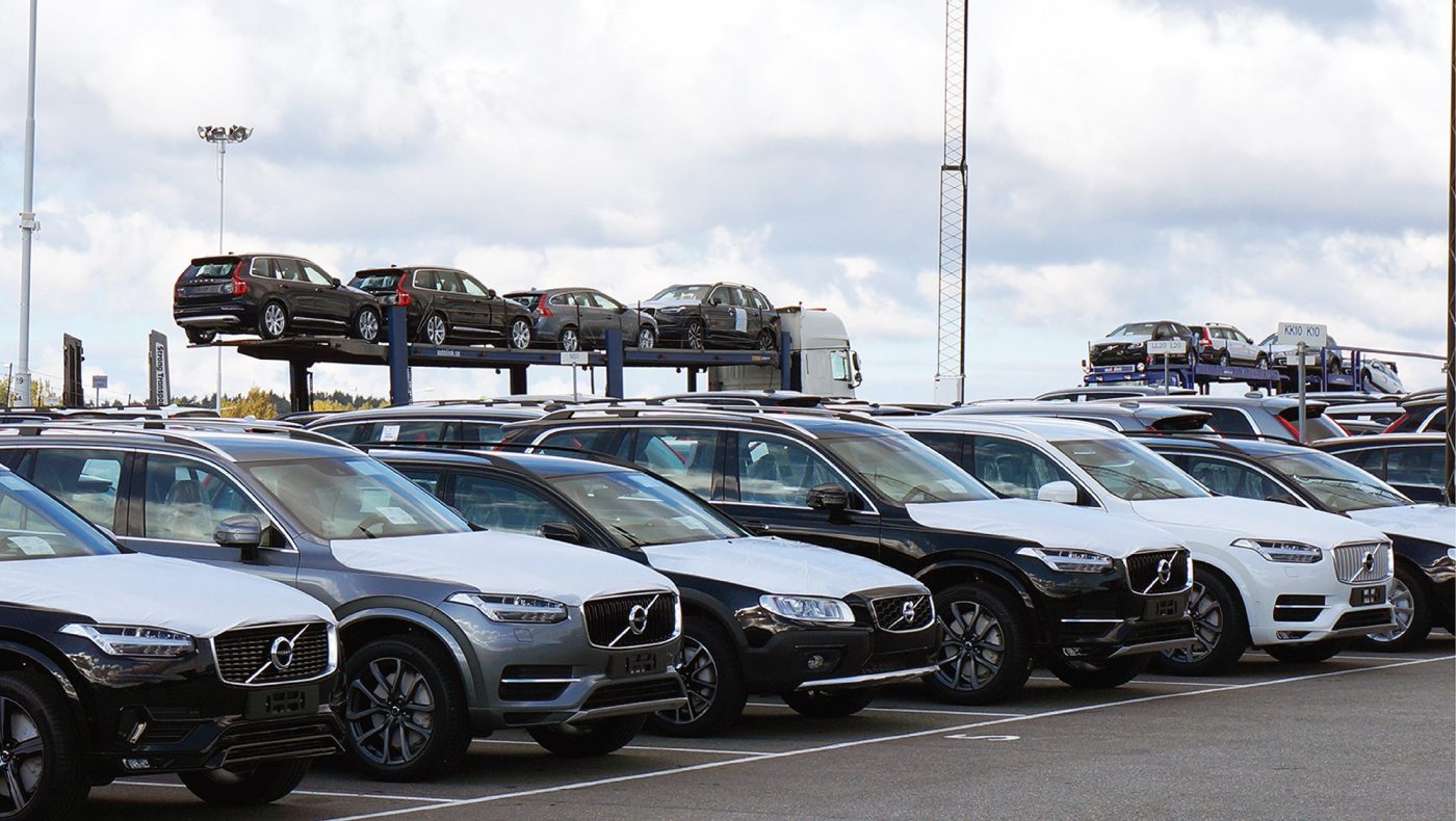 volvo cars standing in a parking lot