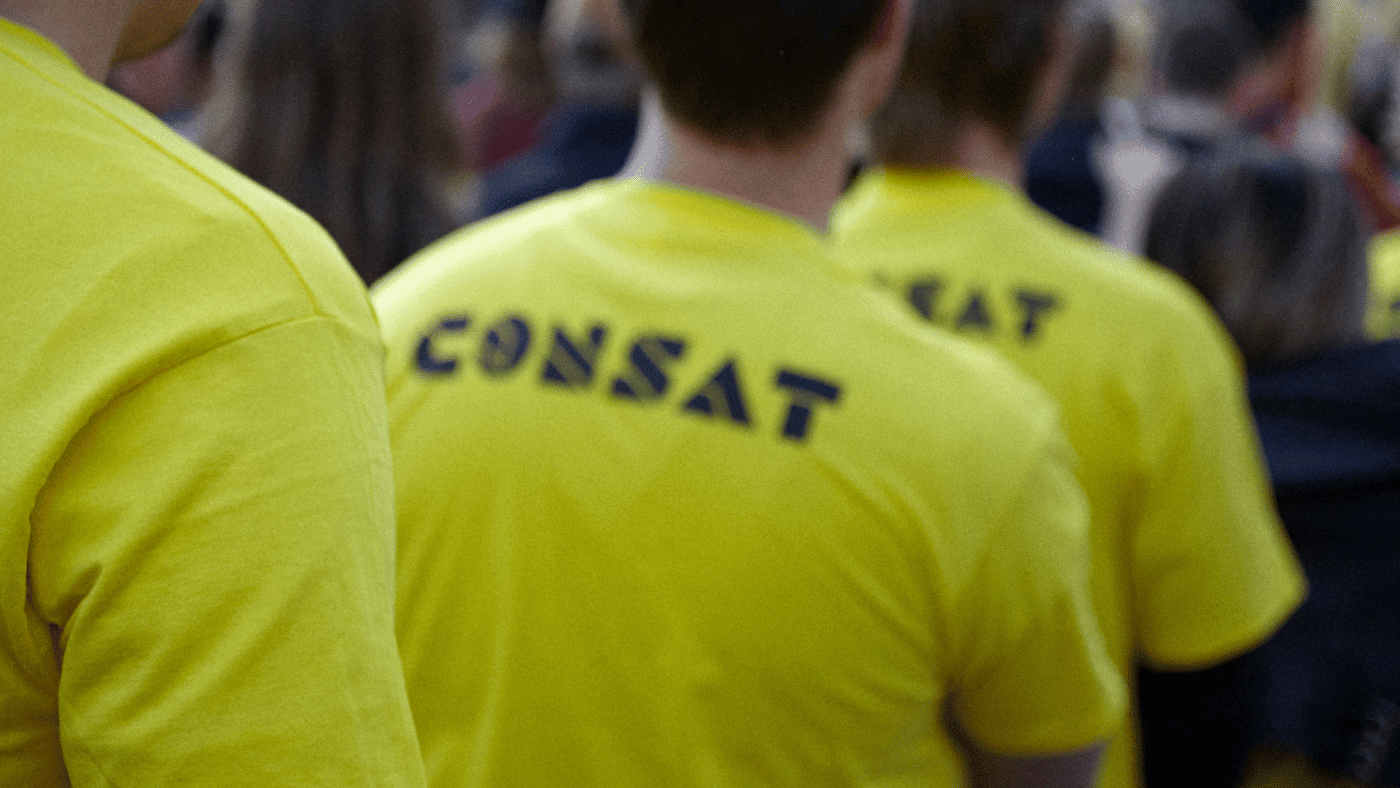 people standing inline with yellow consat t-shirts