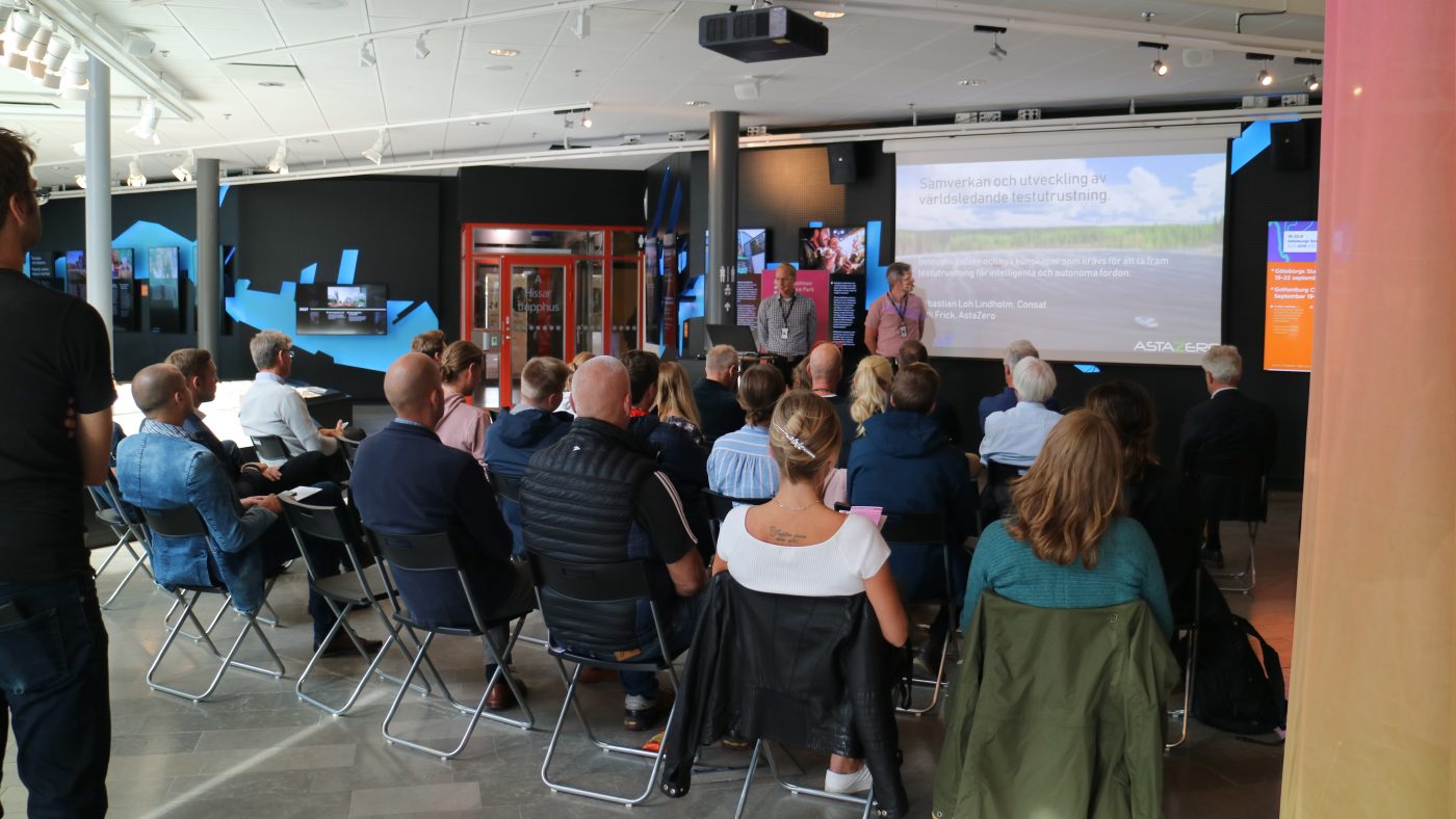 group of people watching a large screen