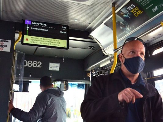 man in a bus pointing