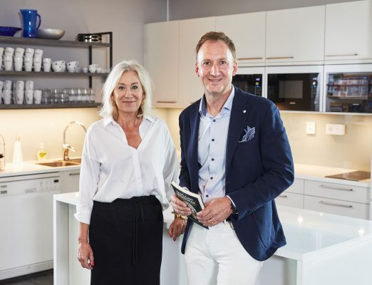 man standing with women in a kitchen