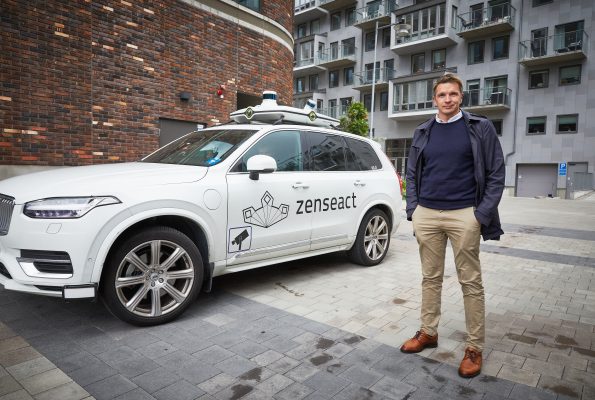 man standing infront of a volvo car